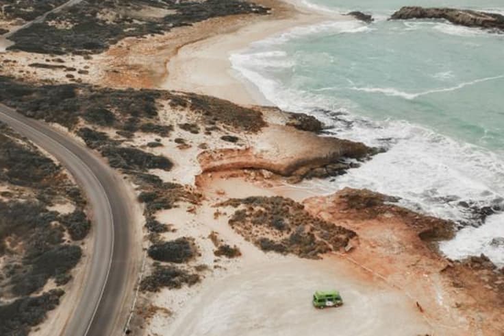 7 day road trip itinerary adelaide to melbourne 4 aerial view of jucy camper on south australia coastline