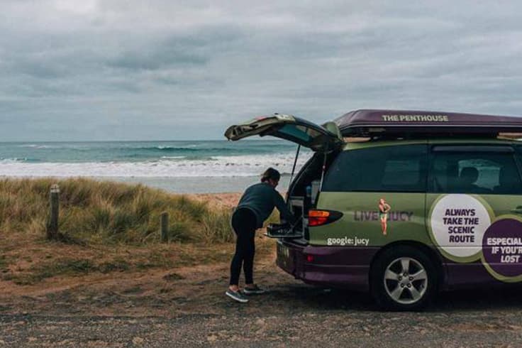 off the beaten track on the great ocean road 2 Person cooking in the back of a JUCY campervan