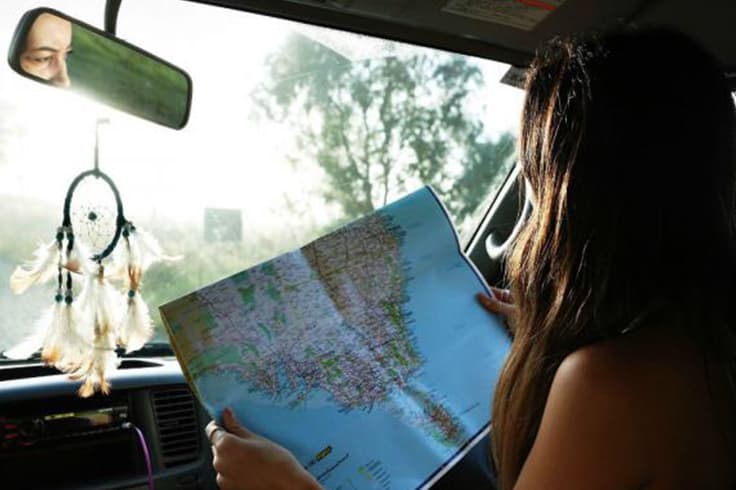 travelling australia in a campervan 1 A girl looking at a map in a campervan