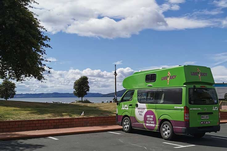 JUCY campervan parked by Rotorua Lake JUCY campervan parked by Rotorua Lake