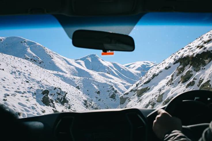 winter camping in nz 2 Snowy mountain view through car windscreen