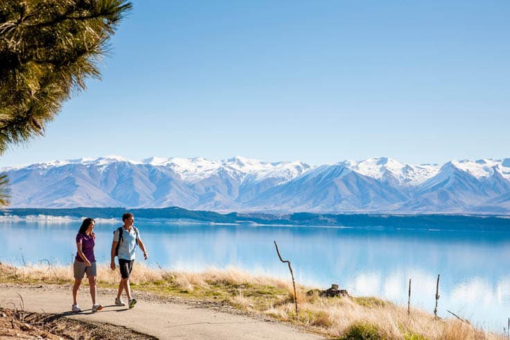 Couple walking by New Zeland lake in winter