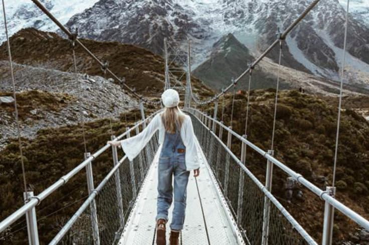 best places to explore winter new zealand 4 Girl on rope bridge in winter
