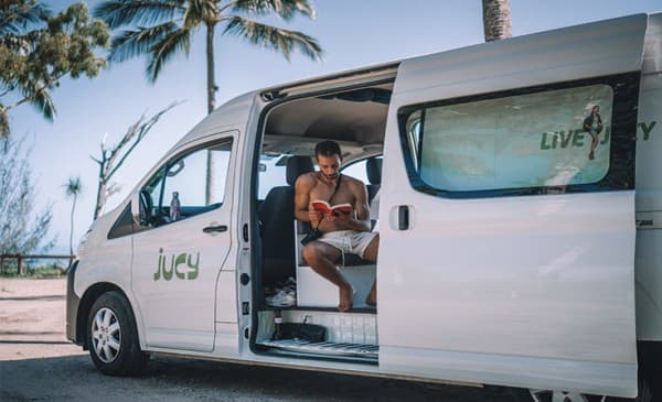 jucy campervan hire cairns man reading book campervan736px x 490px jucy-campervan-man-reading